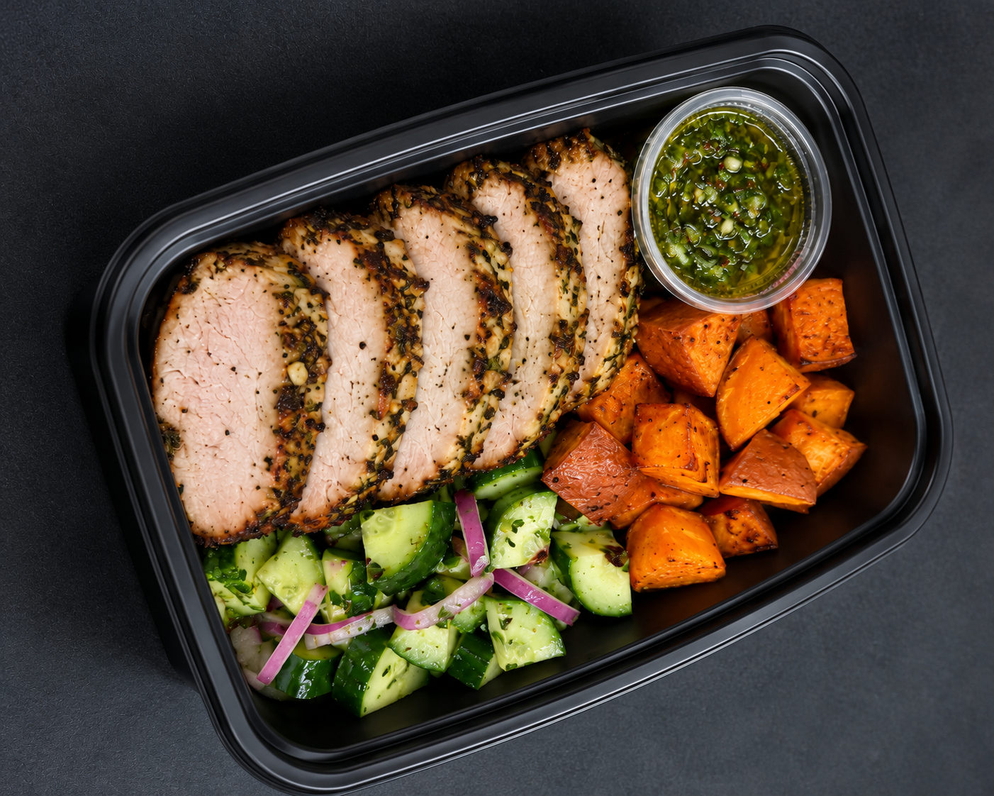 Pork loin with roasted sweet potato and cucumber herb salad in meal-prep container