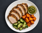 Herb-roasted pork loin with sweet potato, green chimichurri and cucumber herb salad, plated